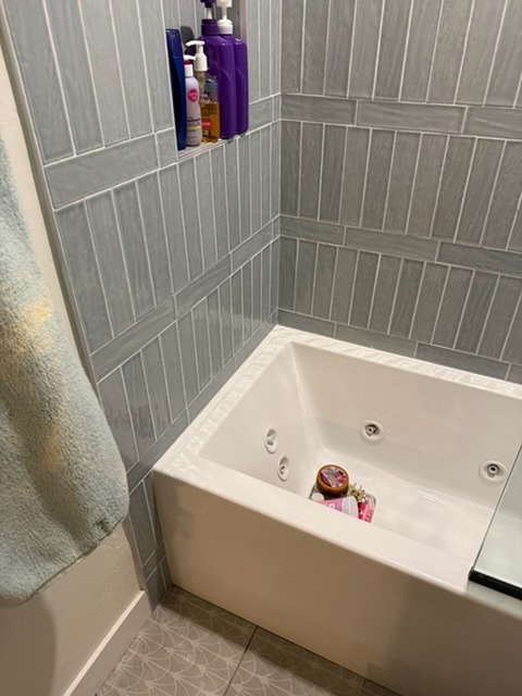 Jetted bathtub and tile floor after professional deep cleaning in Scripps Ranch