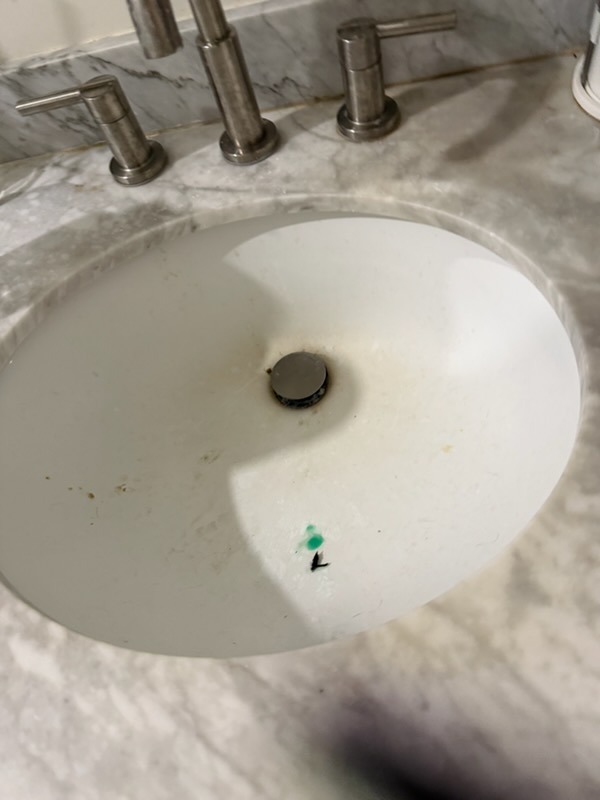 Bathroom marble vanity in Scripps Ranch home before cleaning with water spots and soap buildup